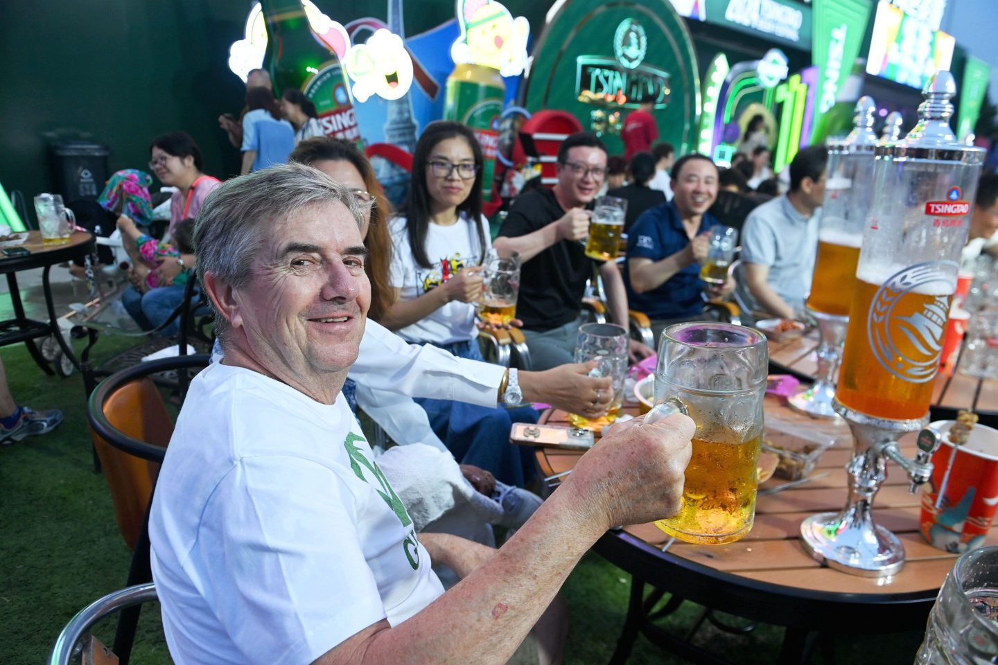 QINGDAO, CHINA - JULY 24, 2024 - Tourists enjoy a drink in a beer pong at the Golden Beach Beer City in Qingdao, East China's Shandong province, July 24, 2024. (Photo credit should read CFOTO/Future Publishing via Getty Images)